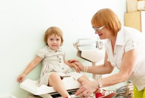 doctor checking whether the child is obese or not.