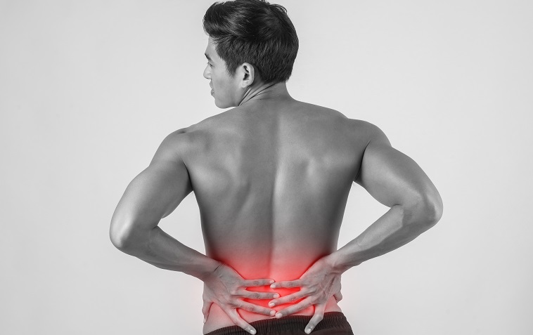 Man holding his back due to pain