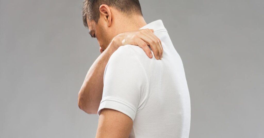 Man suffering from upper back pain